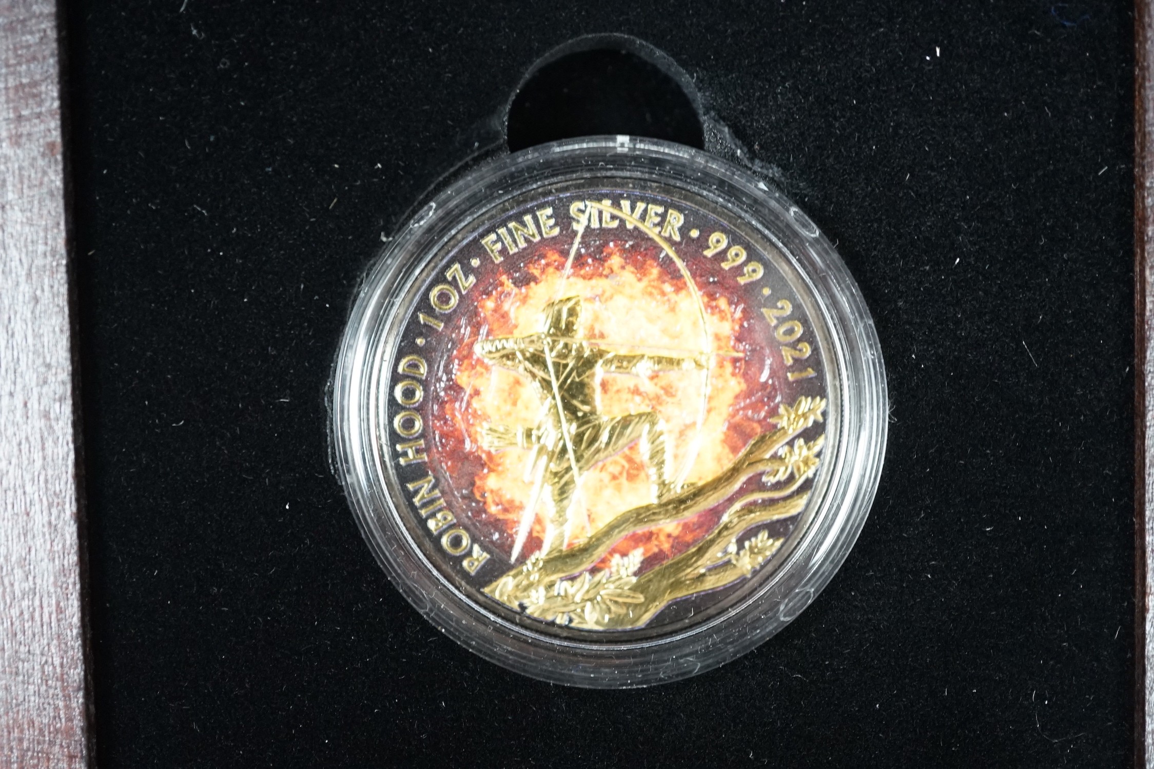 A World Money Fair Red back spider 5oz. Proof silver coin, three art colour 1oz. Silver dollars and a Burning Robin Hood 1oz. BU silver coin (5)